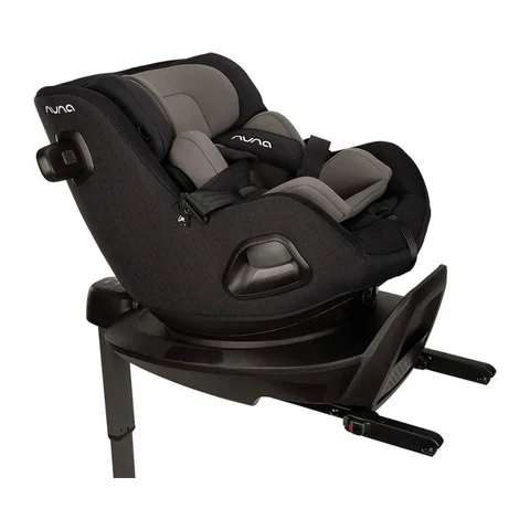 Nuna PRUU rotating car seat in black and grey mounted on its ISOFIX base