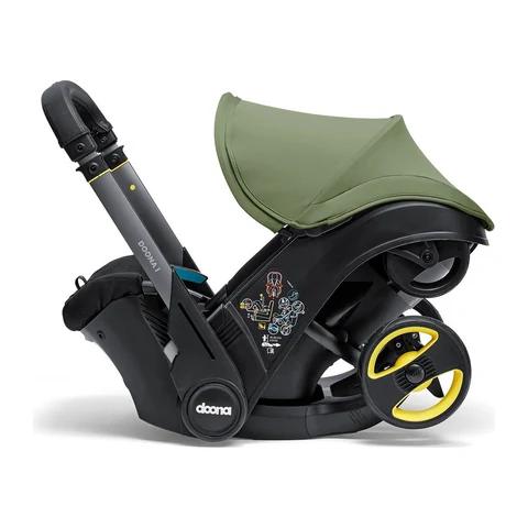 Doona i infant car seat in Desert Green with the wheels folded away underneath in car seat mode