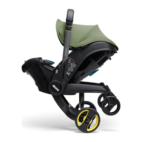 Doona i car seat stroller mid-fold, showing the wheels retracting under the seat shell