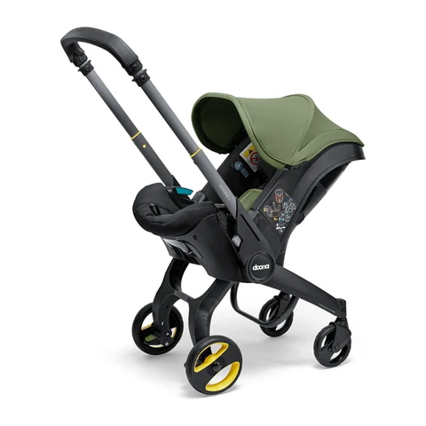 Doona i car seat stroller in Desert Green with its wheels extended in stroller mode